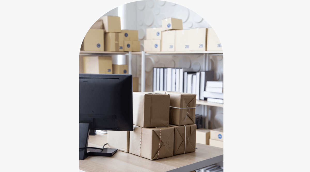 small business office with parcels, desk and laptop 